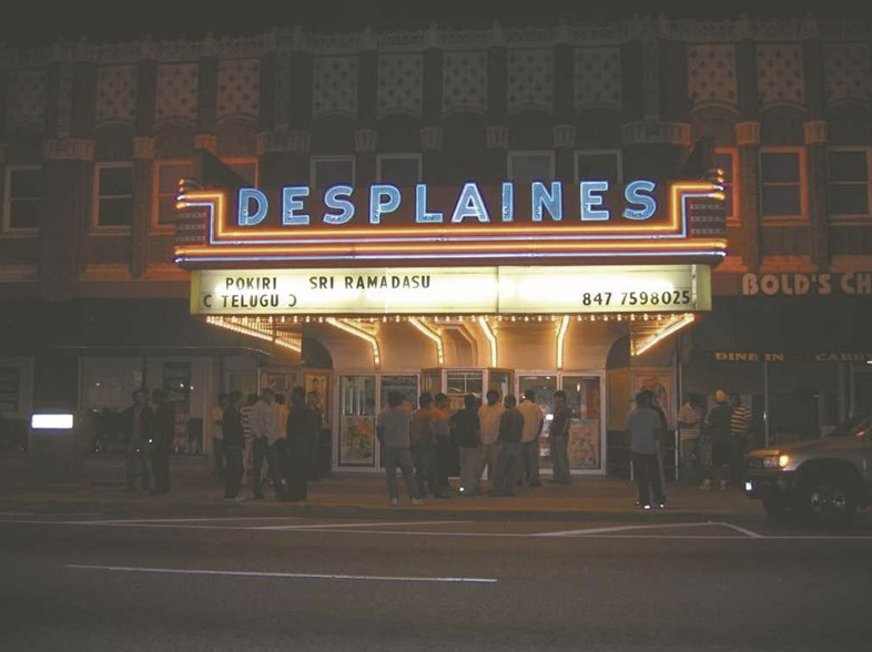 a group of people standing outside a theater